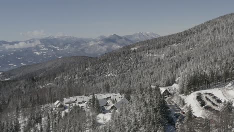 Pohorje-mountains-in-Slovenia-with-Kope-ski-resort-and-Lukov-dom-cabins,-Aerial-pan-left-shot