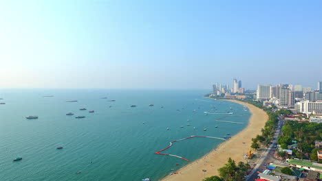 Time-lapse-high-angle-of-a-beach-and-boat-traffic-along-the-Pattaya-city-coastline-Thailand-Copy-Space