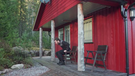 Caucasian-Man-Sits-On-The-Chair-In-The-Back-Of-Red-Cabin