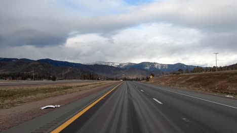 Driving-along-Oregon-freeway,-mountain-backdrop,-point-of-view