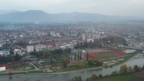 Buildings-And-Athletic-Field-On-Vast-Landscape-In-Kraljevo,-Serbia-On-A-Foggy-Day