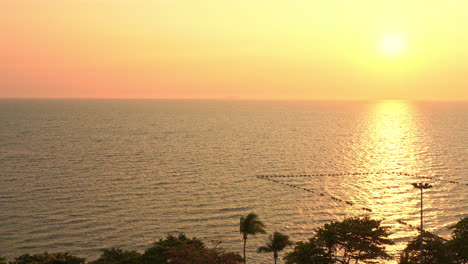 A-golden-sunset-reflects-in-the-Ocean-along-a-tropical-paradise