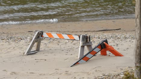 Steigender-Meeresspiegel-Verursacht-Erosion,-Strandsand-Bedeckt-Barrikadenzaun