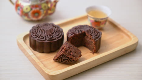 Chinese-moon-cake-dark-chocolate-flavour-on-wood-plate