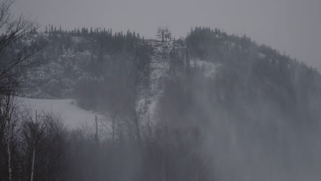 Empty-Chairlifts-At-Mount-Orford-National-Park-In-Quebec,-Canada-In-Winter-With-Mist-From-Snowmaking-Machines---wide-shot,-static