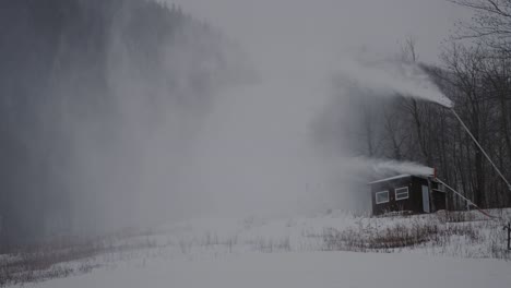 Snowmaking-Machines-Showering-Snow-At-Mount-Orford-National-Park-In-Quebec,-Canada---wide-shot,-slow-motion