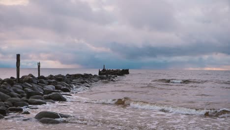 The-sea-wave-washes-away-the-old-abandoned-stone-pier
