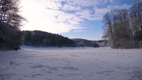 Static-shot-of-winter-wonderland-landscape-and-people-enjoying-a-beautiful-sunny-winter-day-in-Swabia,-Germany