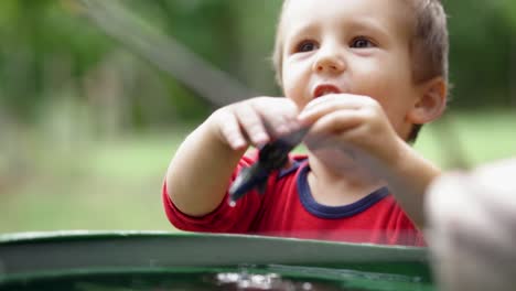 Little-caucasian-boy-having-a-good-time-playing-outdoors-with-the-plastic-airplane,-SLOW-MOTION