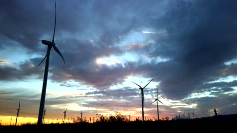 Erneuerbare,-Nachhaltige-Windturbinen-Gegen-Dramatischen-Sonnenuntergang,-Der-Nach-Rechts-Schwenkt