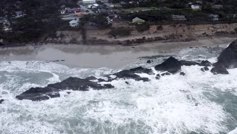 Seal-Rock-on-Oregon-coast,-rugged-waves-breaking-on-shore,-aerial-view