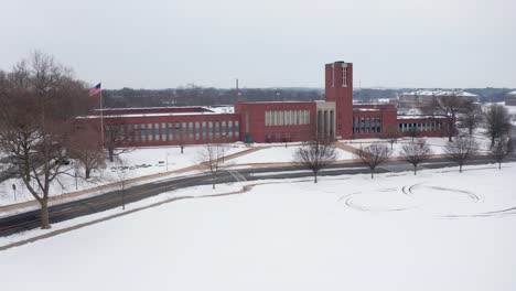 Wide-aerial-of-school-campus-covered-in-white-snow