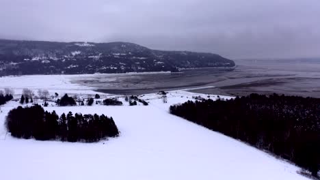 Aerial-shot-turning-around-Baie-Saint-Paul-in-Quebec-in-winter