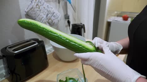 A-cucumber-is-peeled-with-a-potato-peeler