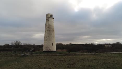 Historic-Leasowe-Lighthouse-maritime-beacon-landmark-aerial-coastal-countryside-Wirral-view-low-right-dolly