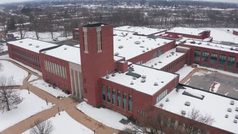 High-aerial-above-school-college-academic-building-during-winter
