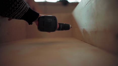 Person-Drilling-Holes-On-The-Wood-Using-Cordless-Driller