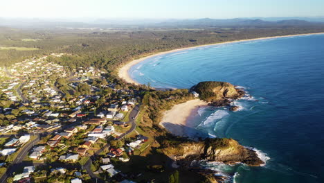 Wide-drone-shot-of-Scotts-Head-town-and-beach-in-Australia-with-blue-Pacific-Ocean-waters