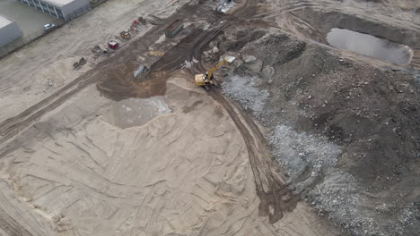 Aerial-of-excavators-collecting-rubble-from-demolished-building-on-construction-site
