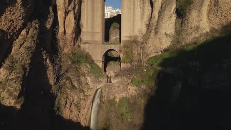 Moving-closer-to-the-waterfall-and-arch-at-Puente-Nuevo-bridge,-Ronda,-Spain