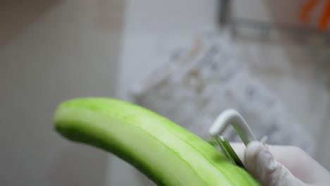 A-cucumber-is-peeled-with-a-potato-peeler