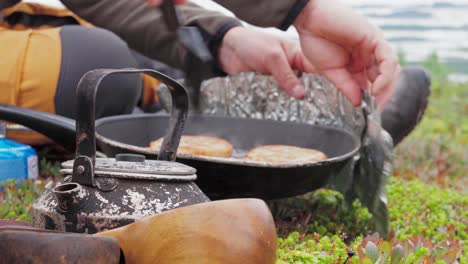 People-Cooking-Meat-Patties-In-The-Meadow-Of-Norway