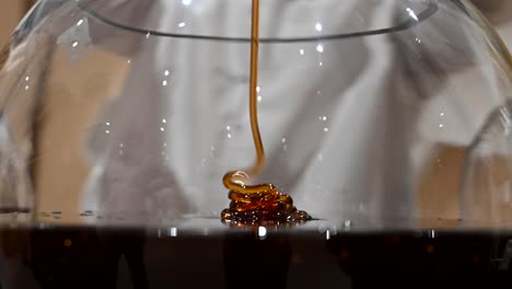 4K-Close-up-Shot:-Thick-dark-UAE's-Acacia-honey-dripping,-Organic-honey-dipper-in-glasses-bowl,-Healthy-organic-Thick-honey,-Healthy-Food-Concept