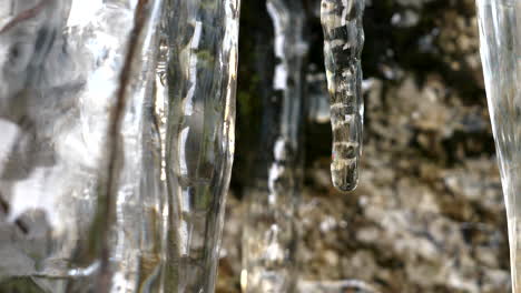 Macro-Glittering-icicles-Melting-ice-drops-in-mountain-cave-in-spring,-close-up