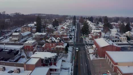 Aerial-establishing-shot-of-American-small-town-covered-in-winter-snow