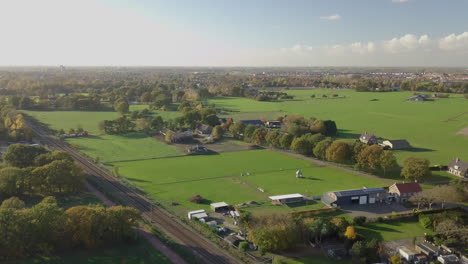 Aerial-drone-shot-of-flying-up-near-the-railways-in-the-countryside-of-the-Netherlands