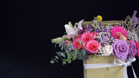 Floral-arrangement-slider-shot-inside-golden-box-lily-rose-daisy-gerbera