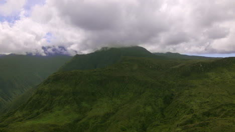 Rainforest-mountain-range-on-Maui-island,-green-peak-in-clouds,-aerial-view