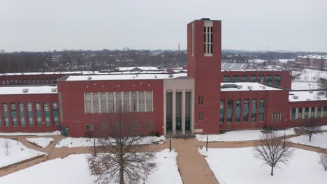 Front-entrance,-facade-of-large-American-school,-college-building-during-winter