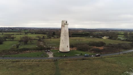 Historic-Leasowe-Lighthouse-maritime-beacon-landmark-aerial-coastal-countryside-Wirral-view-low-to-high-left
