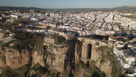 Aerial-reveal-of-the-town-of-Ronda,-Spain,-during-sunset-with-a-clean-sky
