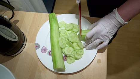 A-peeled-green-cucumber-that-is-sliced-filmed-from-above