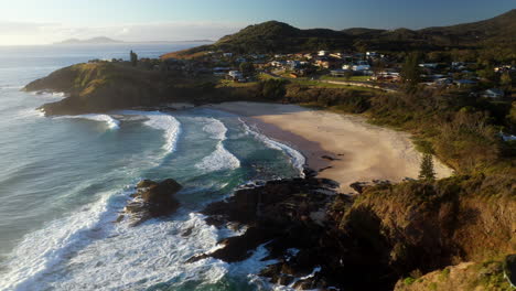 Cinematic-drone-shot-of-Scotts-Head-beach-revealing-town-in-Australia