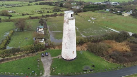 Historic-Leasowe-Lighthouse-maritime-beacon-landmark-aerial-coastal-countryside-Wirral-view-pull-back-rising-shot