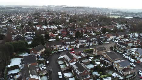 Snowy-aerial-village-residential-neighbourhood-Winter-frozen-North-West-houses-and-roads-slow-zoom-in