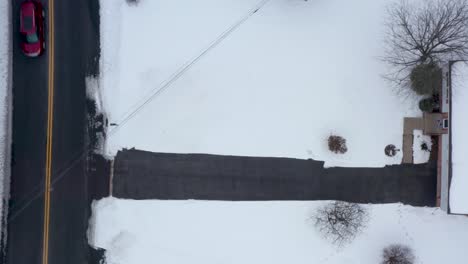 Top-down-aerial-of-snow-covered-home