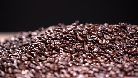 Coffee-beans-falling-in-a-pile-HD-Slow-motion-on-black-background