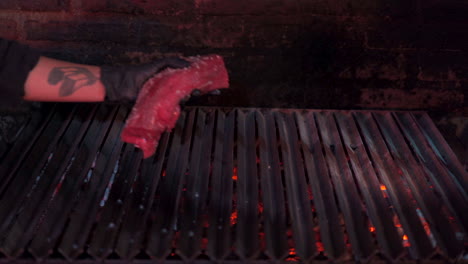 putting-raw-meat-in-the-grill-barbecue-chef