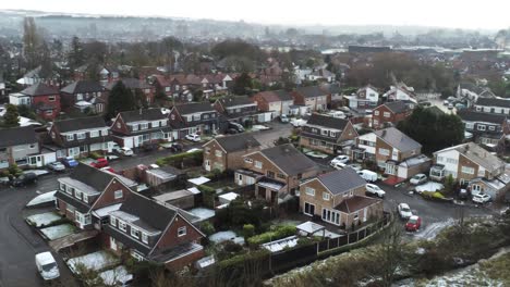 Snowy-aerial-village-residential-neighbourhood-Winter-frozen-North-West-houses-and-roads-drift-right