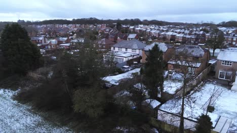Snowy-aerial-village-residential-neighbourhood-Winter-frozen-North-West-rising-up-over-houses-and-roads