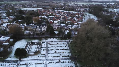 Snowy-aerial-village-residential-neighbourhood-Winter-frozen-North-West-houses-and-roads-birdseye-track-right