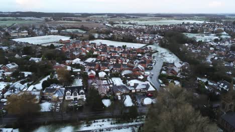 Snowy-aerial-village-residential-neighbourhood-Winter-frozen-North-West-houses-and-roads-slow-left-dolly-shot