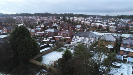 Snowy-aerial-village-residential-neighbourhood-Winter-frozen-North-West-houses-and-roads-descend-low