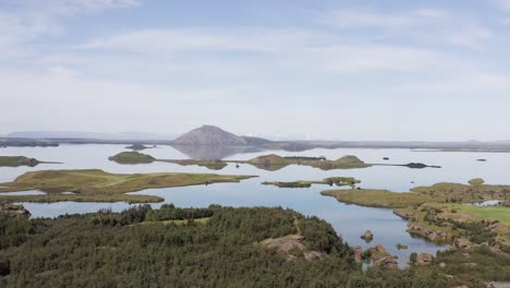 Aerial-of-stunning-Myvatn-lake-with-calm-water-and-volcano-in-background
