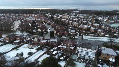 Snowy-aerial-village-residential-neighbourhood-Winter-frozen-North-West-houses-and-roads-descending-right-dolly