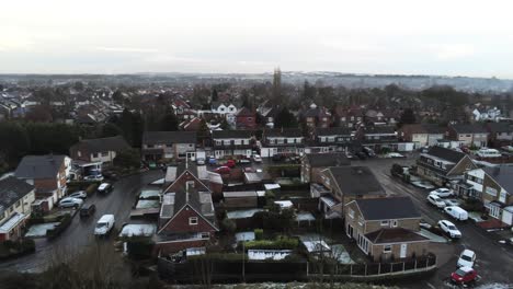 Snowy-aerial-village-residential-neighbourhood-Winter-frozen-North-West-houses-and-roads-slow-rising-pan-right